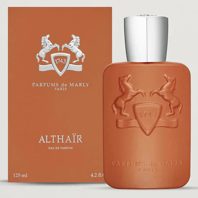 Brown perfume bottle with silver cap and matching box on a light gray background